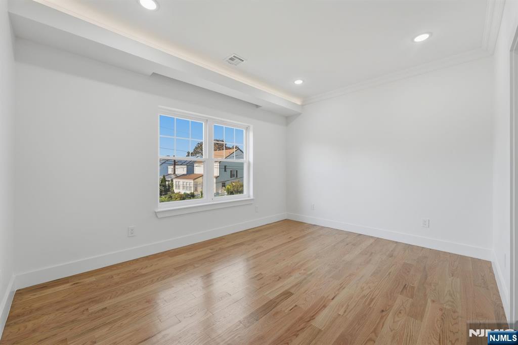 275 Longview Road Union, NJ 07083 - Photo 35 of 43 a view of an empty room with a window and wooden floor