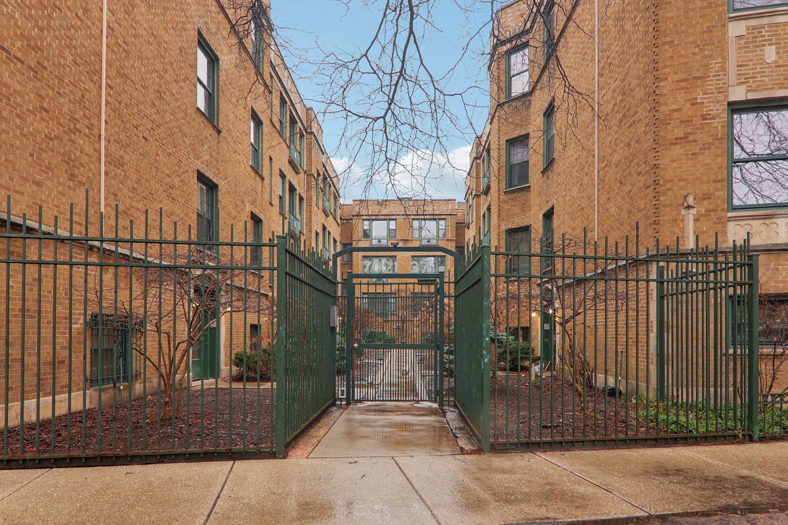 7023.5 North Sheridan Road, Unit 3S Chicago, IL 60626 - Photo 1 of 19 a view of a brick house with a small yard