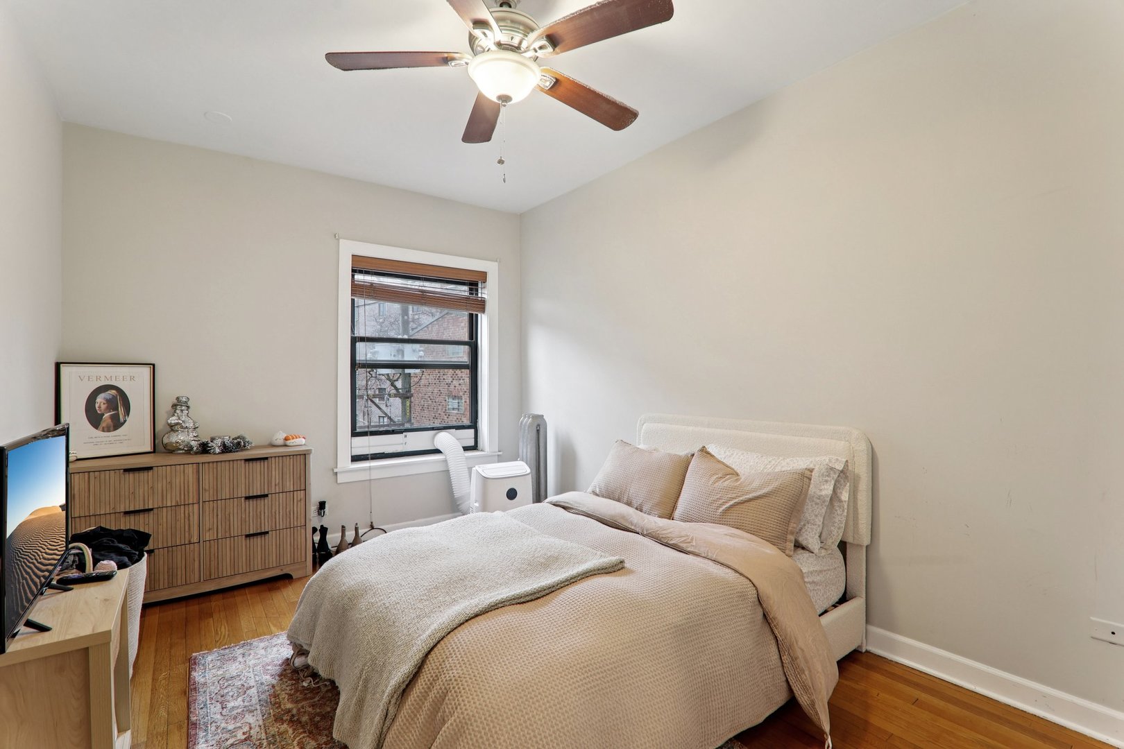7023.5 North Sheridan Road, Unit 3S Chicago, IL 60626 - Photo 13 of 19 a bedroom with a bed and a chandelier