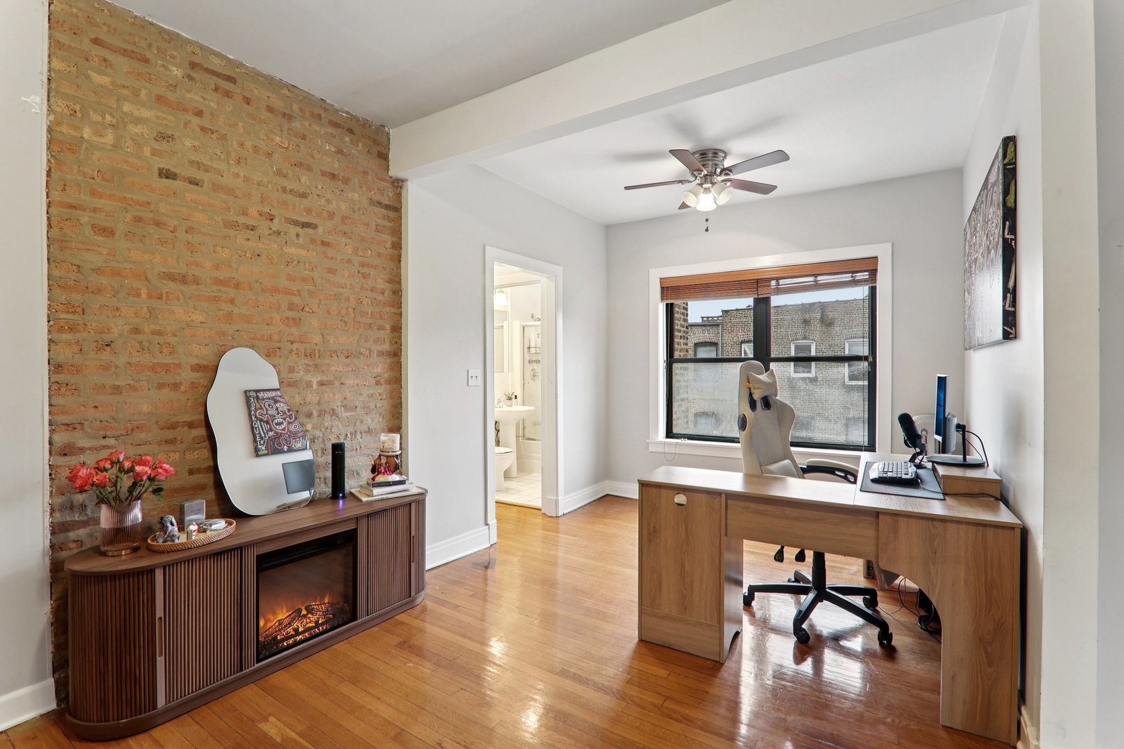7023.5 North Sheridan Road, Unit 3S Chicago, IL 60626 - Photo 7 of 19 a living room with furniture wooden floor and a fireplace