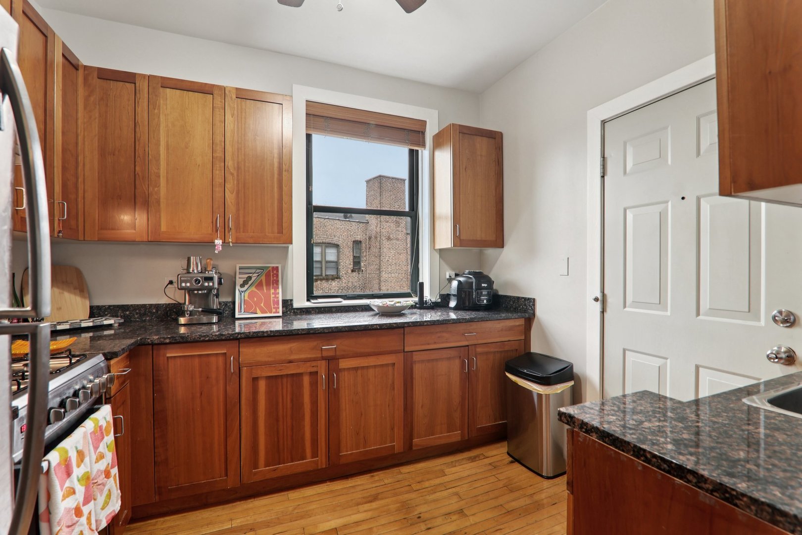 7023.5 North Sheridan Road, Unit 3S Chicago, IL 60626 - Photo 9 of 19 a kitchen with stainless steel appliances granite countertop a sink stove and cabinets