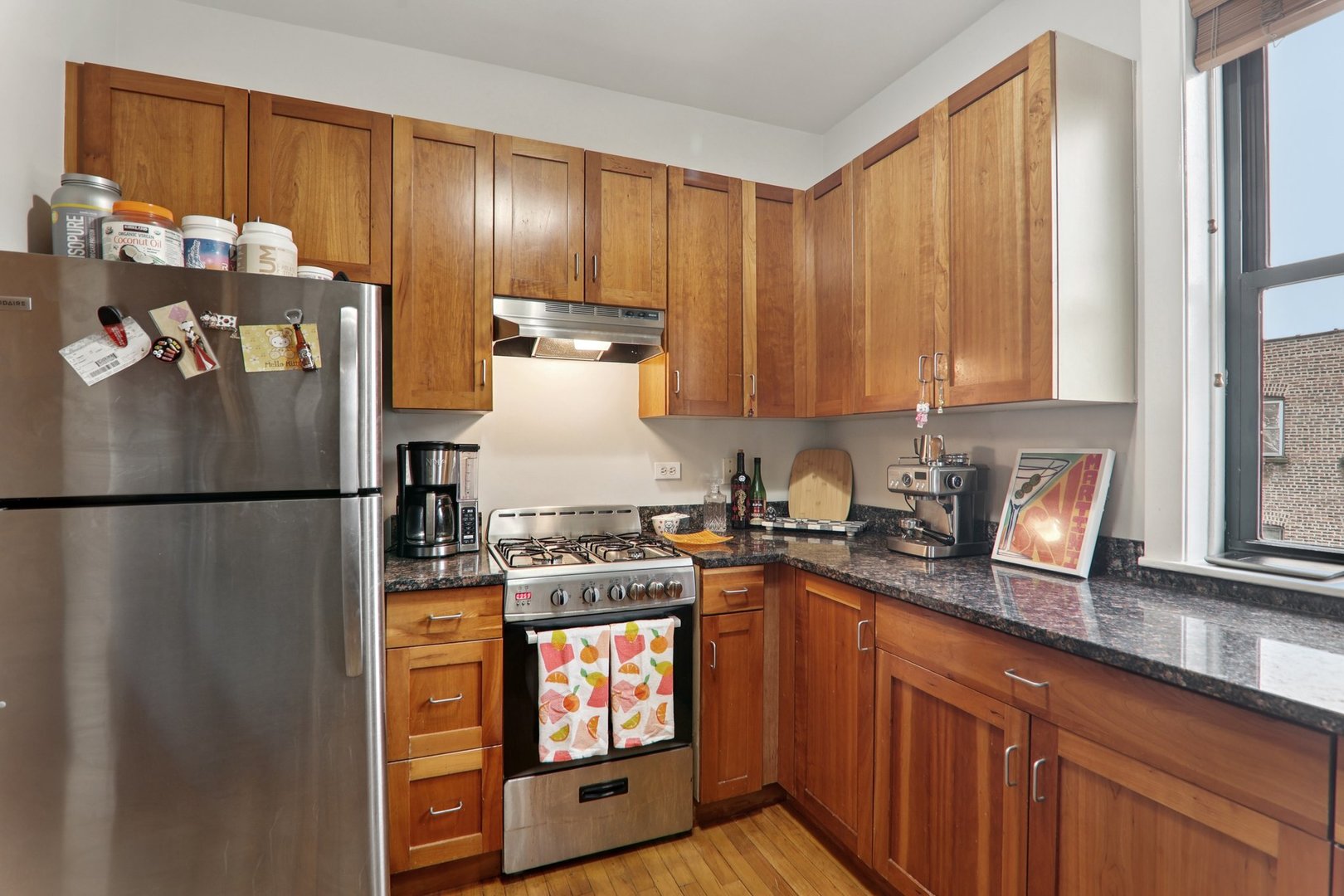 7023.5 North Sheridan Road, Unit 3S Chicago, IL 60626 - Photo 10 of 19 a kitchen with stainless steel appliances granite countertop a refrigerator stove and sink