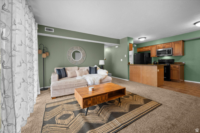 2095 South Main Street, Unit 13 Bountiful, UT 84010 - Photo 1 of 45 Living area featuring light colored carpet and light tile patterned floors