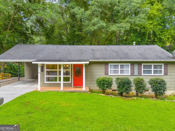 a view of a house with a garden and plants