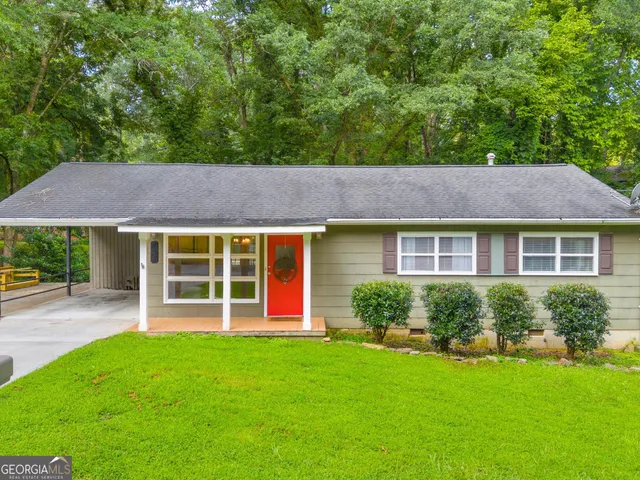 a view of a house with a garden and plants