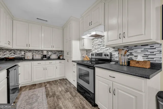 a view of a bedroom with furniture and chandelier fan