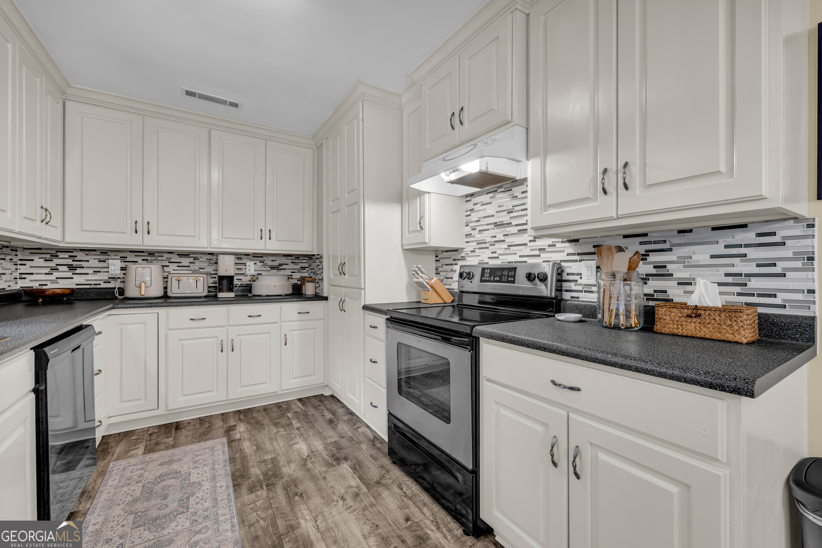 1168 Rosedale Street Toccoa, GA 30577 - Photo 13 of 23 a kitchen with granite countertop white cabinets and white stainless steel appliances