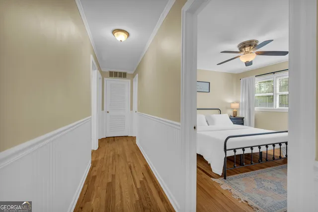 a bedroom with a bed and a tv on the dresser