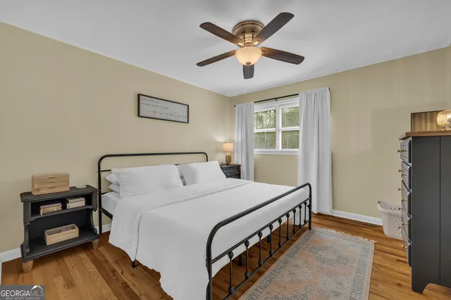 a bathroom with a granite countertop sink toilet and mirror