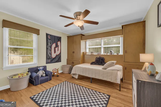 a bedroom with a bed and wooden floor