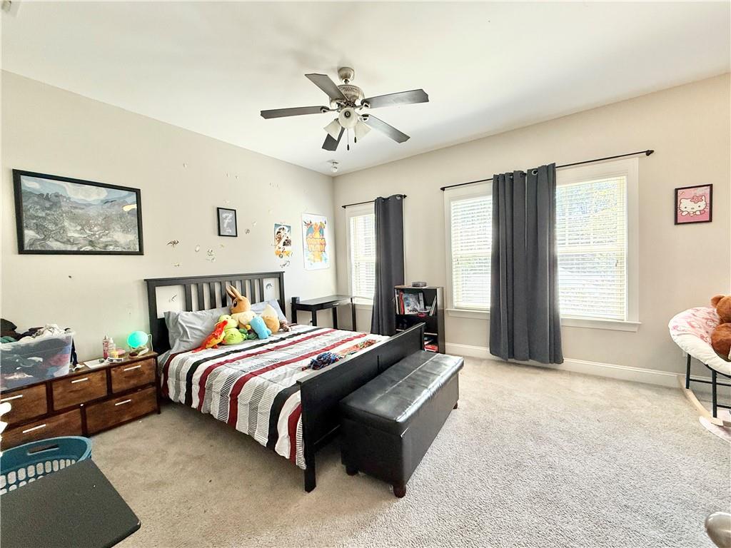 1817 Hislop Lane, Unit 7 Atlanta, GA 30345 - Photo 13 of 32 a bedroom with a bed and a chandelier