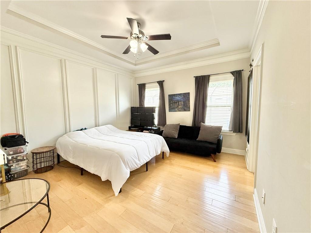 1817 Hislop Lane, Unit 7 Atlanta, GA 30345 - Photo 16 of 32 a spacious bedroom with a bed a couch and a chandelier