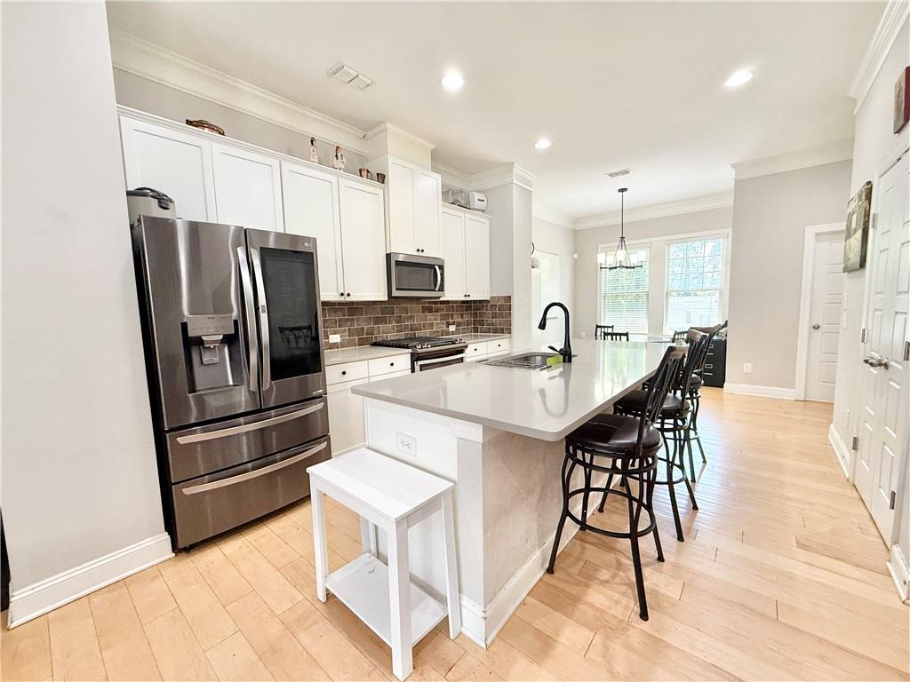 1817 Hislop Lane, Unit 7 Atlanta, GA 30345 - Photo 6 of 32 a kitchen with stainless steel appliances kitchen island granite countertop a refrigerator and a stove top oven