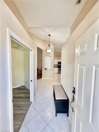 a bedroom with a bed and lamp with window
