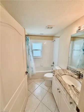 a bedroom with a bed and a ceiling fan