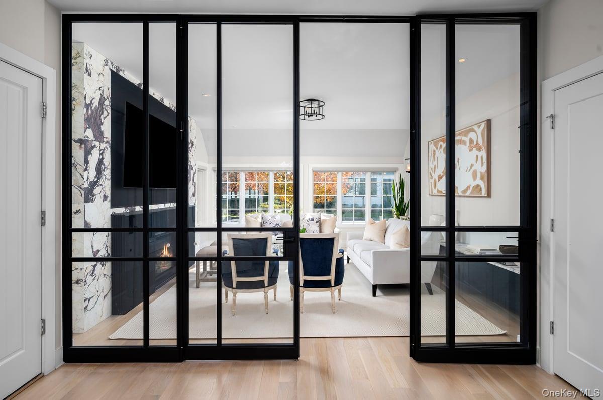 1 Primrose Lane Rye Brook, NY 10573 - Photo 12 of 42 Doorway featuring wood finished floors and expansive windows