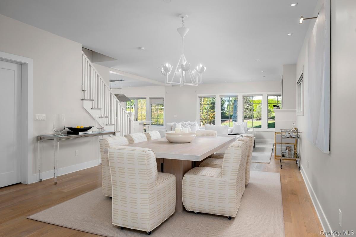 1 Primrose Lane Rye Brook, NY 10573 - Photo 2 of 42 Dining area with plenty of natural light, light wood finished floors, stairs, a chandelier, and recessed lighting
