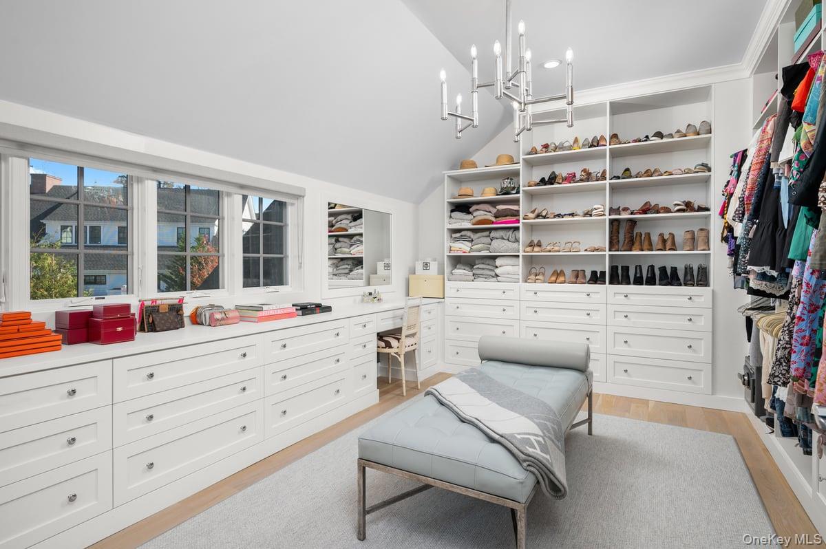 1 Primrose Lane Rye Brook, NY 10573 - Photo 21 of 42 Spacious closet with light wood finished floors, lofted ceiling, and a chandelier