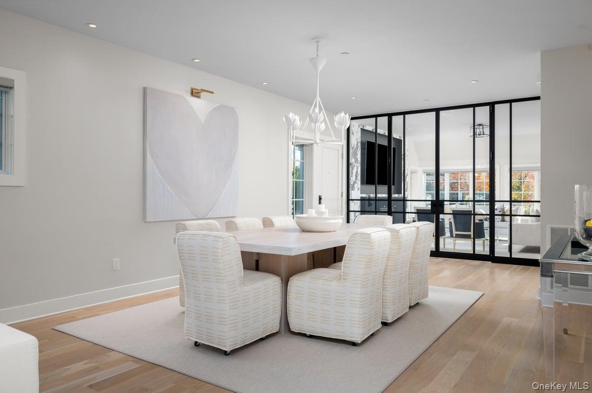 1 Primrose Lane Rye Brook, NY 10573 - Photo 3 of 42 Dining space with expansive windows, light wood-style flooring, recessed lighting, and a chandelier