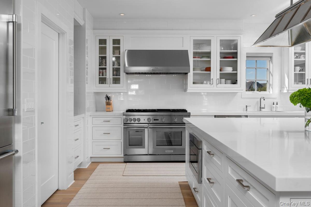 1 Primrose Lane Rye Brook, NY 10573 - Photo 9 of 42 Kitchen with white cabinets, high quality appliances, ventilation hood, tasteful backsplash, and recessed lighting