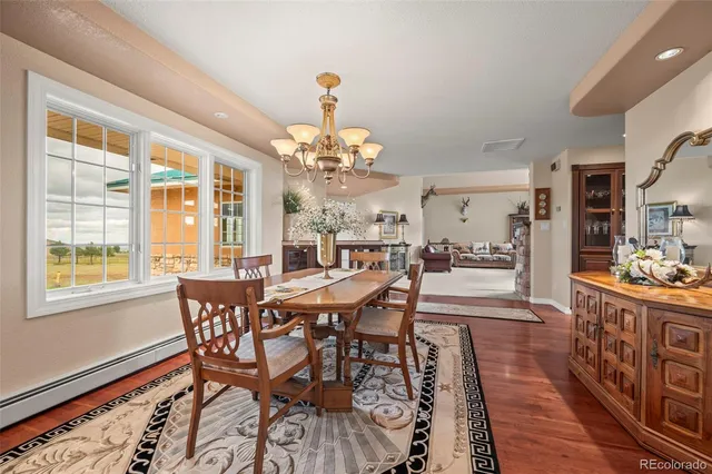 a view of a dining room with furniture window and wooden floor