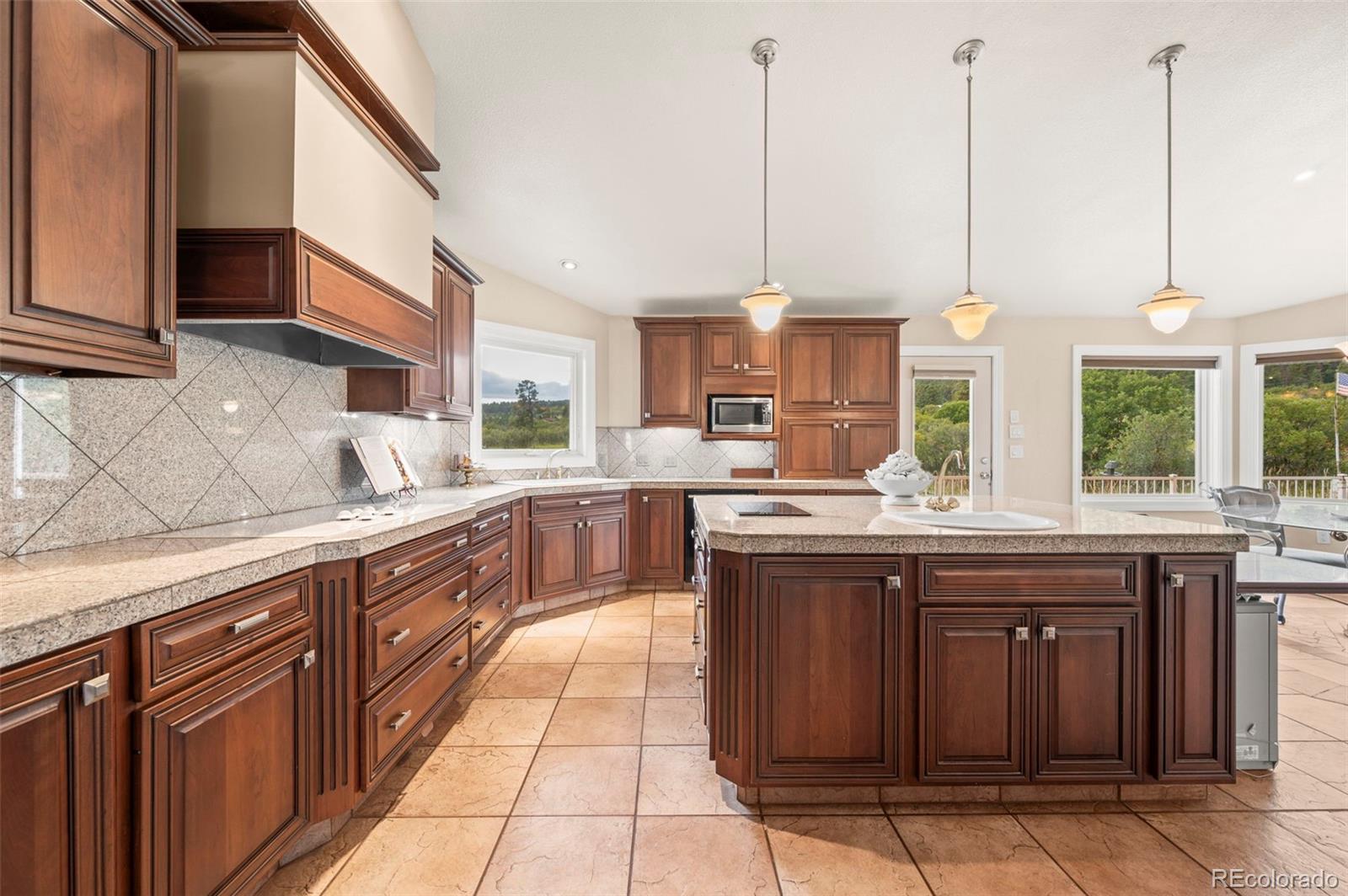 10650 Baxter Road Rye, CO 81069 - Photo 19 of 50 a kitchen with stainless steel appliances granite countertop a sink and wooden cabinets
