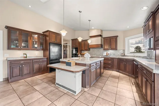 a kitchen with stainless steel appliances a sink stove top oven and cabinets