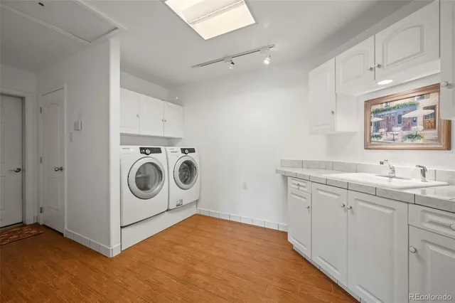 a utility room with sink dryer and washer
