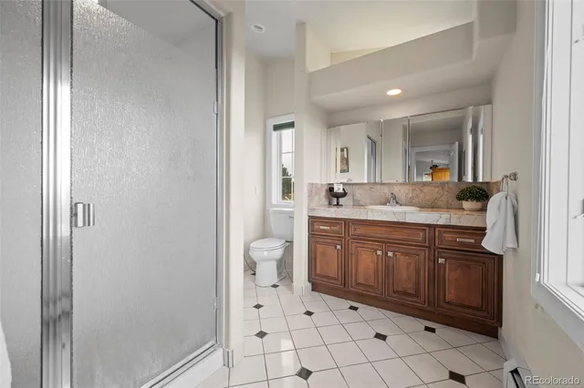 a spacious bathroom with a granite countertop sink and a mirror