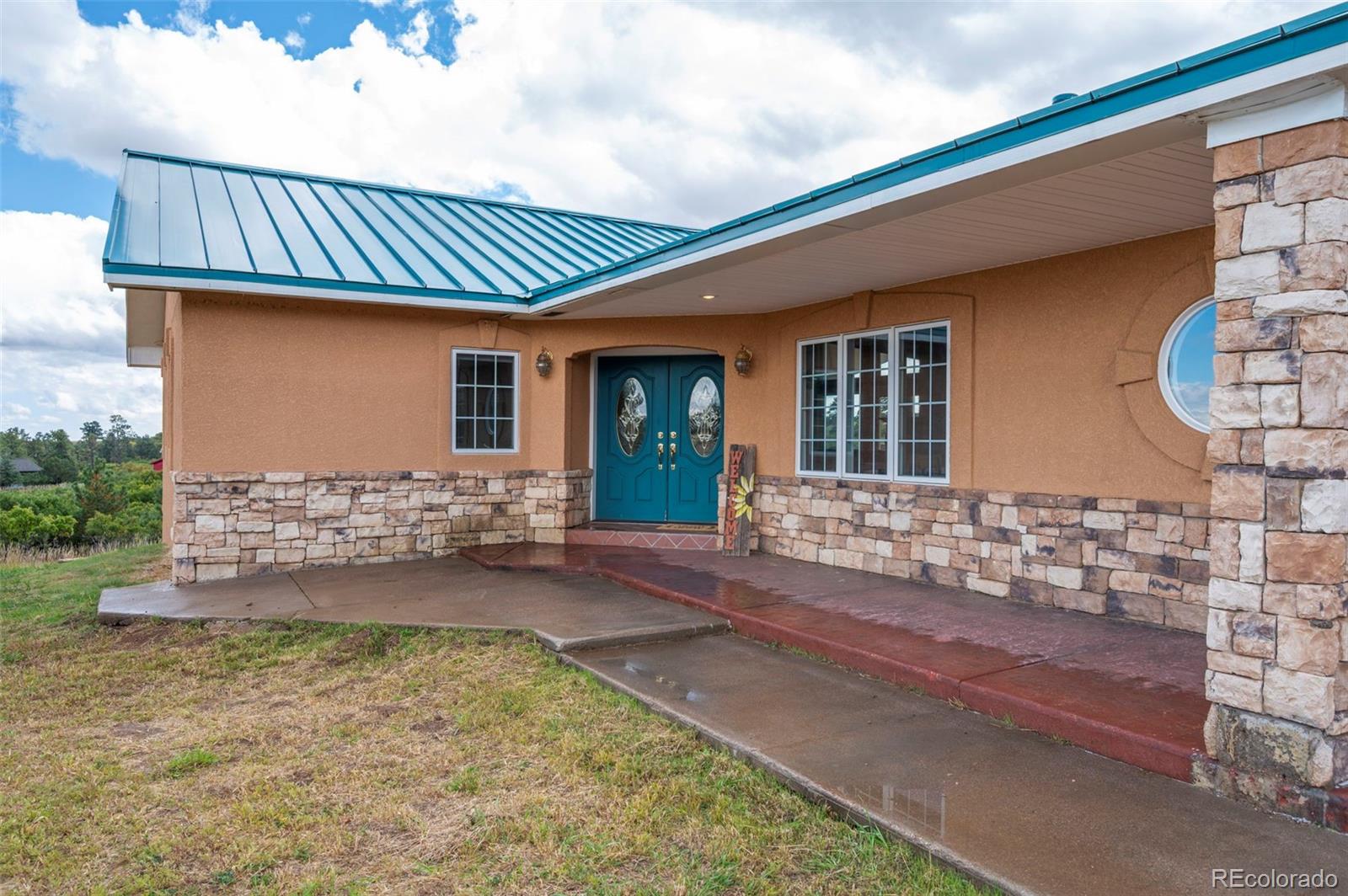 10650 Baxter Road Rye, CO 81069 - Photo 8 of 50 a front view of a house with garden