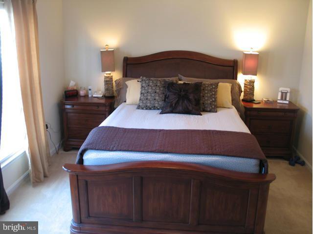 1893 Scaffold Way Odenton, MD 21113 - Photo 13 of 22 a bedroom with a bed and a mirror