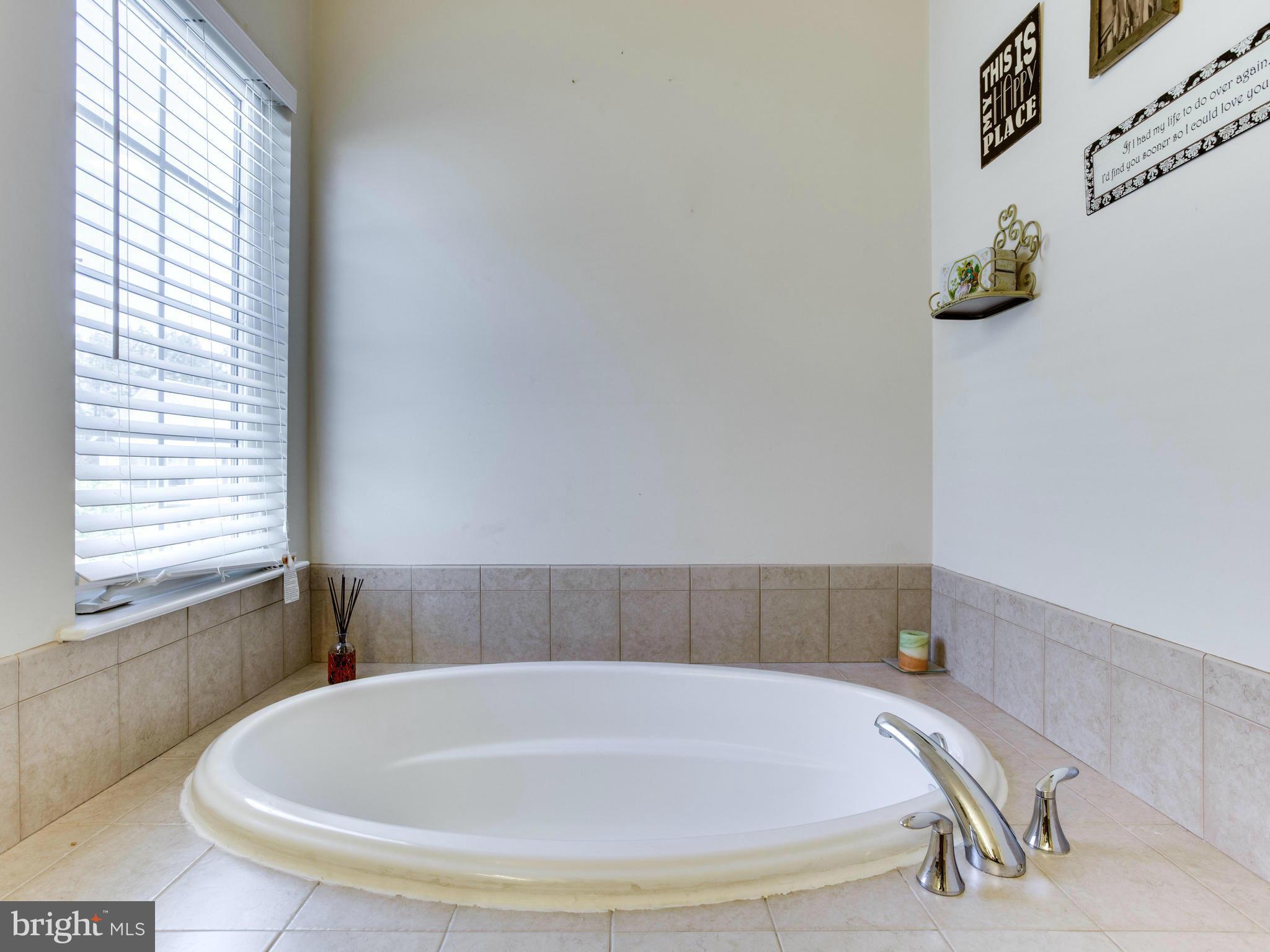 1893 Scaffold Way Odenton, MD 21113 - Photo 15 of 22 a white bath tub sitting in a bathroom next to a window