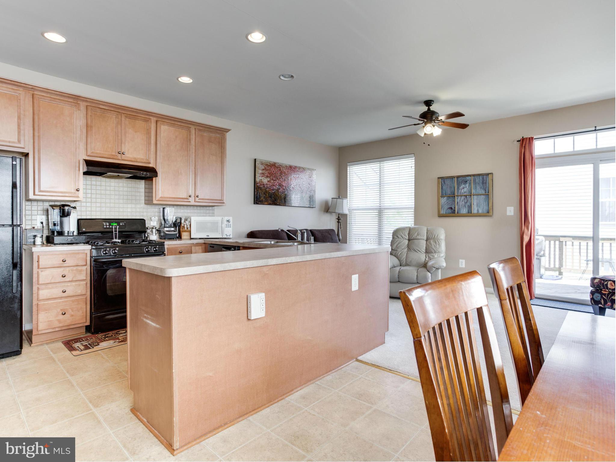 1893 Scaffold Way Odenton, MD 21113 - Photo 8 of 22 a kitchen with stainless steel appliances granite countertop a refrigerator stove microwave and sink