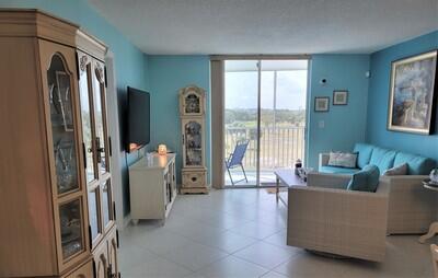 6699 Northwest 2nd Avenue, Unit PHI Boca Raton, FL 33487 - Photo 12 of 33 a living room with furniture and a flat screen tv