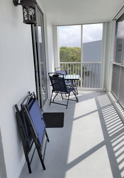 6699 Northwest 2nd Avenue, Unit PHI Boca Raton, FL 33487 - Photo 15 of 33 a living room with furniture and a floor to ceiling window