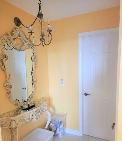 6699 Northwest 2nd Avenue, Unit PHI Boca Raton, FL 33487 - Photo 19 of 33 a bathroom with a granite countertop sink and a mirror