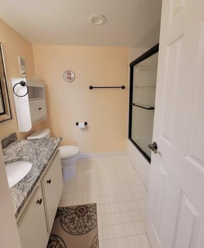 6699 Northwest 2nd Avenue, Unit PHI Boca Raton, FL 33487 - Photo 20 of 33 a bathroom with a granite countertop sink toilet and shower