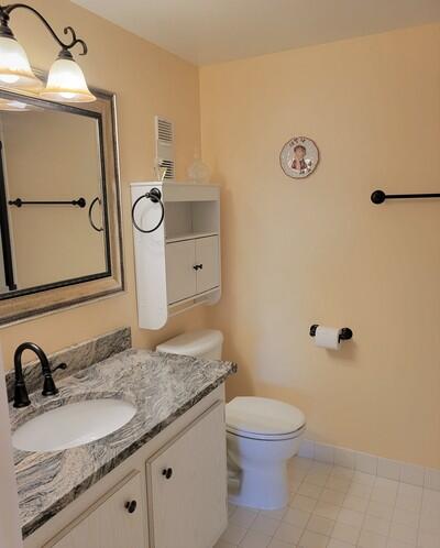 6699 Northwest 2nd Avenue, Unit PHI Boca Raton, FL 33487 - Photo 21 of 33 a bathroom with a granite countertop sink and a mirror
