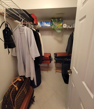 6699 Northwest 2nd Avenue, Unit PHI Boca Raton, FL 33487 - Photo 23 of 33 a view of walk in closet with clothes and shoes