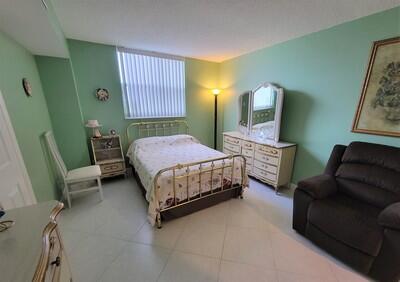 6699 Northwest 2nd Avenue, Unit PHI Boca Raton, FL 33487 - Photo 24 of 33 a bedroom with a bed chair and window