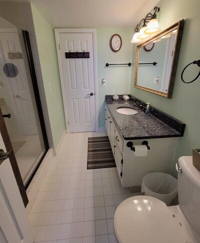 6699 Northwest 2nd Avenue, Unit PHI Boca Raton, FL 33487 - Photo 26 of 33 a bathroom with a sink a toilet and mirror