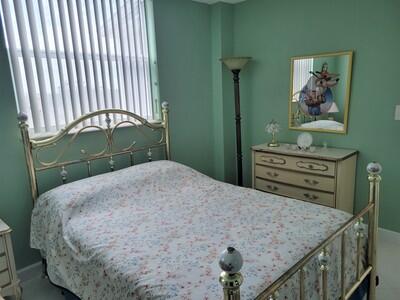 6699 Northwest 2nd Avenue, Unit PHI Boca Raton, FL 33487 - Photo 31 of 33 a bed sitting in a bedroom next to a window