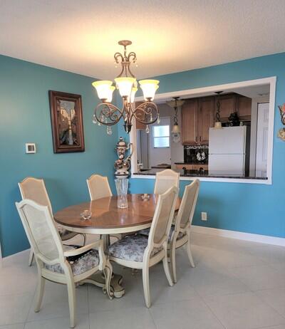 6699 Northwest 2nd Avenue, Unit PHI Boca Raton, FL 33487 - Photo 6 of 33 a dining room with furniture and window