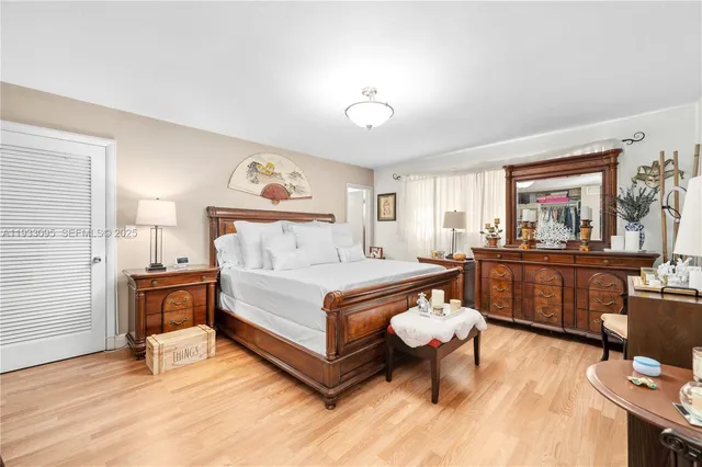 a bed room with a bed and a chandelier