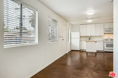 a view of a kitchen with wooden floor