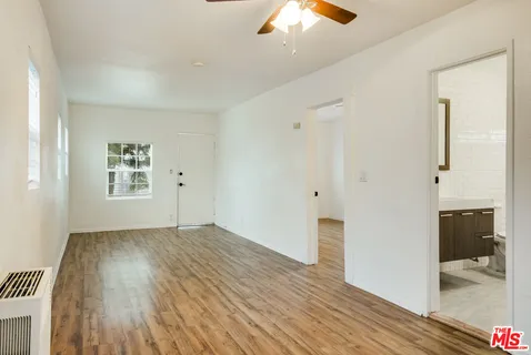 wooden floor in an empty room with a window
