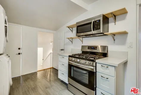 a kitchen with a stove and a microwave