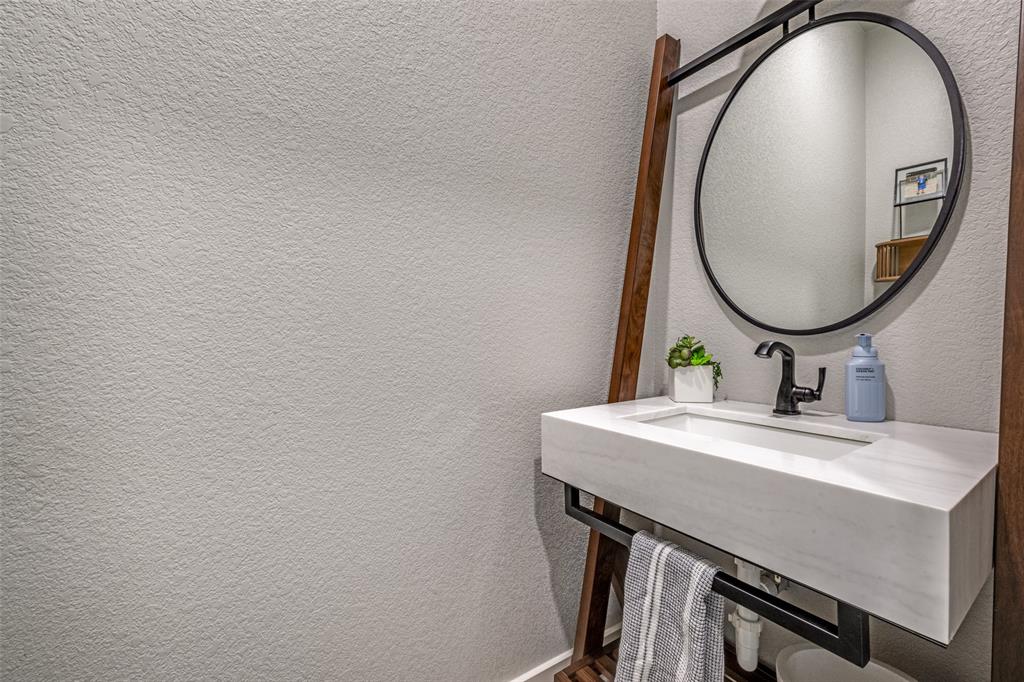 123 Proctor Lane Decatur, TX 76234 - Photo 12 of 25 a bathroom with a sink and a mirror