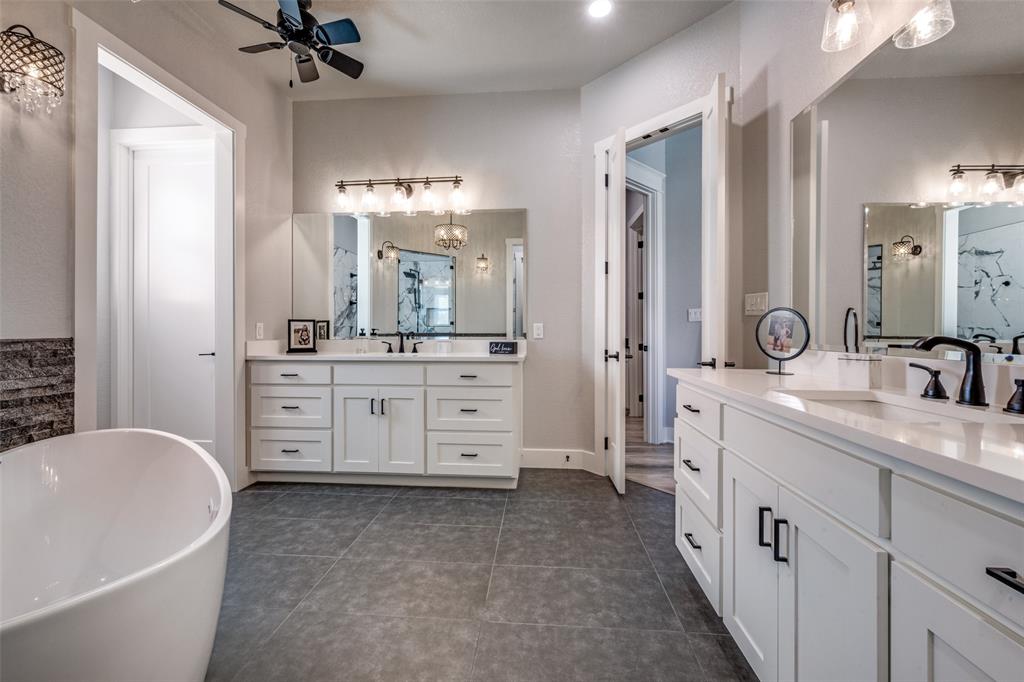 123 Proctor Lane Decatur, TX 76234 - Photo 15 of 25 a spacious bathroom with a double vanity sink a mirror a bathtub and shower