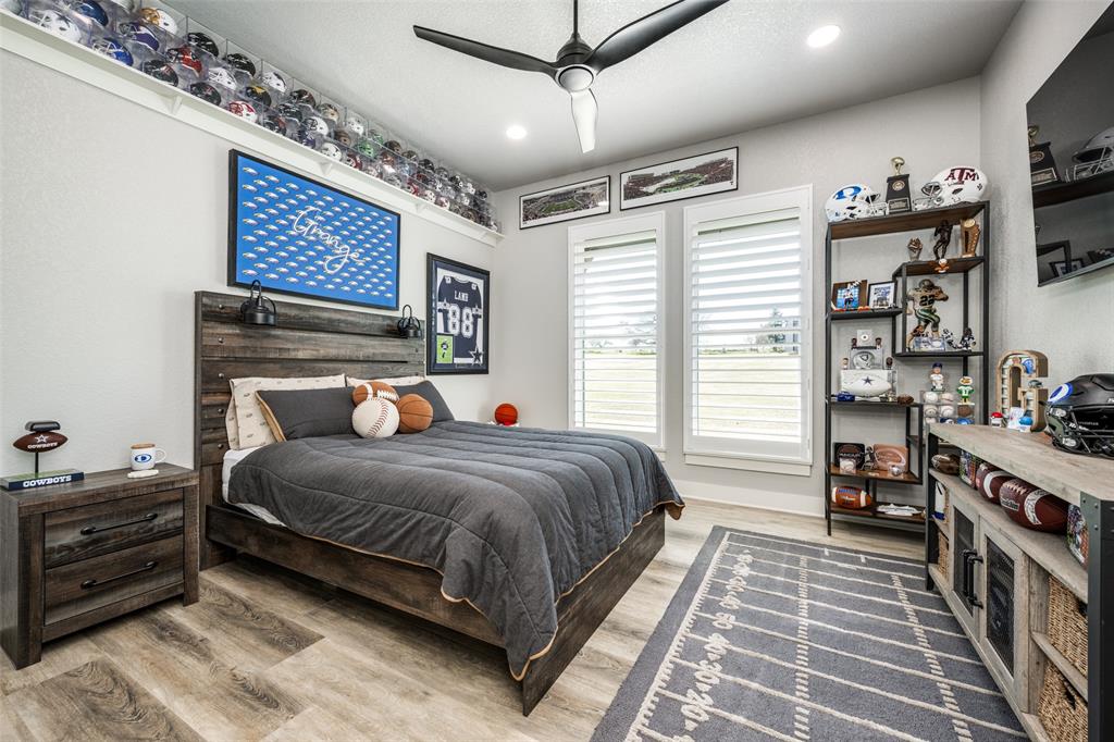 123 Proctor Lane Decatur, TX 76234 - Photo 17 of 25 a bedroom with a bed a dresser and book shelf